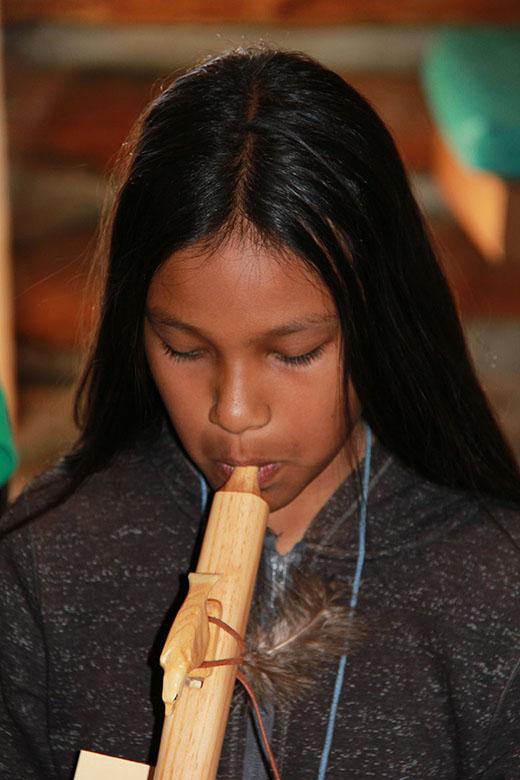 Child playing the Native American flute